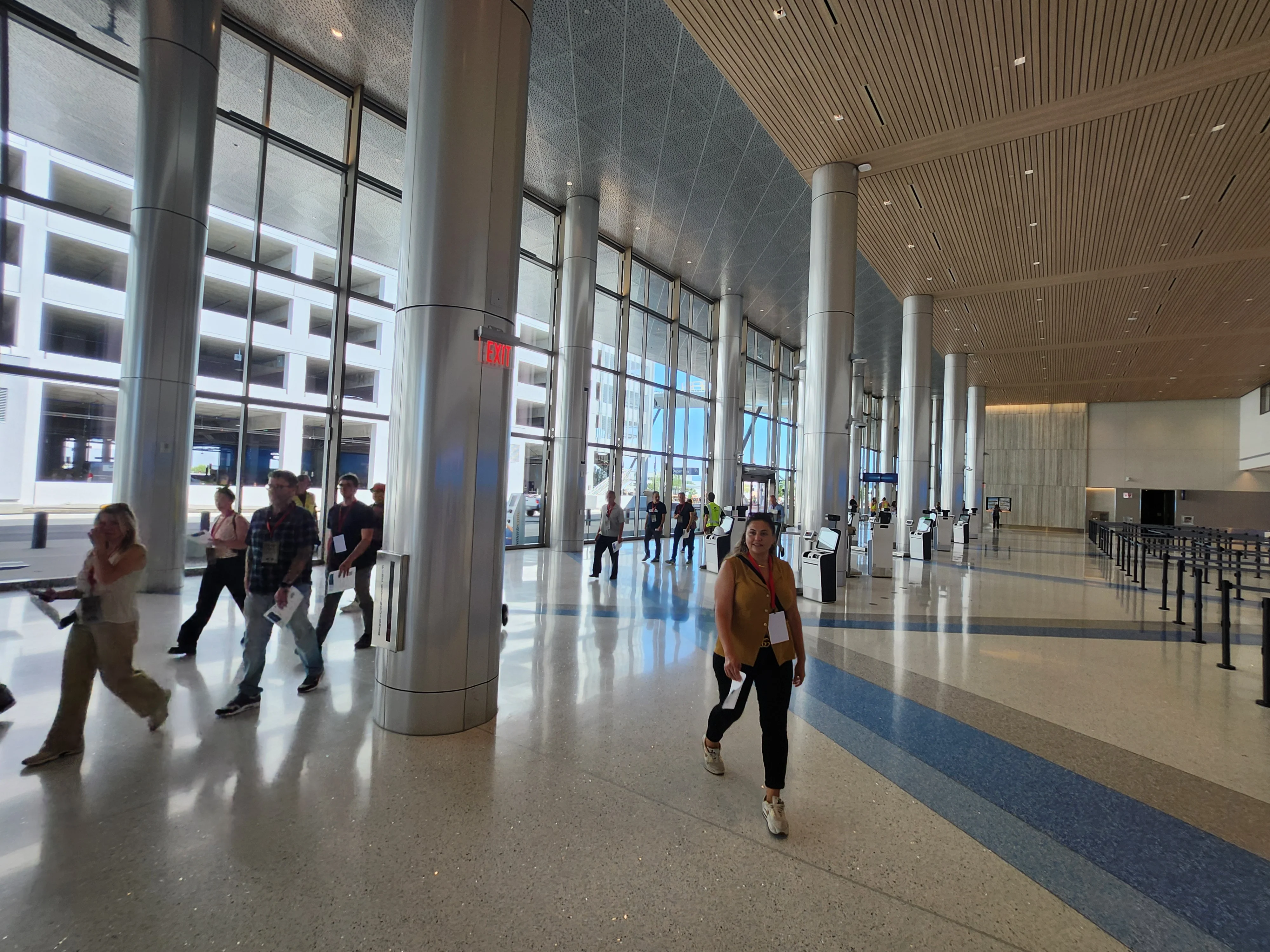 Trial participants walking through the new check-in hall, flooded with natural light